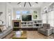 Comfortable living room with a fireplace, built-in shelves, and large windows at 9032 Tavolini Ter, Windermere, FL 34786