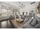 Open-concept living room featuring modern decor, dark hardwood floors and ample seating at 9032 Tavolini Ter, Windermere, FL 34786
