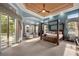 Luxurious main bedroom suite with a four-poster bed, sitting area, and large windows at 9032 Tavolini Ter, Windermere, FL 34786