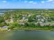 Scenic aerial view of a lakeside community with lush greenery and charming homes at 996 Fairview Ave, Mount Dora, FL 32757