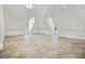 A spacious attic area with a ceiling fan and natural light at 996 Fairview Ave, Mount Dora, FL 32757