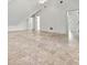 A finished attic area with tile flooring and multiple doorways at 996 Fairview Ave, Mount Dora, FL 32757