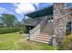 Beautiful backyard featuring a stone facade, stairs to the upper level, and lush landscaping at 996 Fairview Ave, Mount Dora, FL 32757