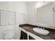 Bathroom featuring a vanity with granite countertop, an oval sink, and louvered cabinet doors at 996 Fairview Ave, Mount Dora, FL 32757