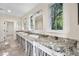 Spacious bathroom with double sink vanity with granite countertop and large windows at 996 Fairview Ave, Mount Dora, FL 32757