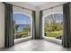 Bright corner space featuring bay windows with beautiful water views and lush landscaping, creating a serene atmosphere at 996 Fairview Ave, Mount Dora, FL 32757