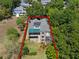Stunning aerial view of a multi-story home with a lush, landscaped yard surrounded by mature trees at 996 Fairview Ave, Mount Dora, FL 32757