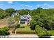 Charming multi-story home with stone accents and a well-manicured lawn, surrounded by mature trees at 996 Fairview Ave, Mount Dora, FL 32757