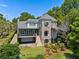 Stately home showcasing stone facade, balconies, and lush landscaping at 996 Fairview Ave, Mount Dora, FL 32757