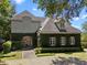 Unique exterior elevation with stone accents, ivy-covered walls, and mature landscaping at 996 Fairview Ave, Mount Dora, FL 32757