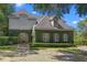 Charming home featuring ivy-covered walls, stone accents, and professionally manicured landscape at 996 Fairview Ave, Mount Dora, FL 32757