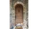 Solid wood front door surrounded by a stone archway, offering an elegant and secure entry point to the home at 996 Fairview Ave, Mount Dora, FL 32757