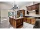 A gourmet kitchen features custom wood cabinetry, granite counters, and an island at 996 Fairview Ave, Mount Dora, FL 32757