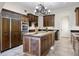Stylish kitchen with wood cabinets, stainless steel appliances, a central island, and elegant lighting fixtures at 996 Fairview Ave, Mount Dora, FL 32757