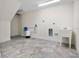 Bright laundry room featuring tile floors, a utility sink and included water filtration system at 996 Fairview Ave, Mount Dora, FL 32757
