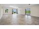 Spacious living area with tile flooring, large windows and access to the backyard at 996 Fairview Ave, Mount Dora, FL 32757
