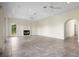 A living room featuring a corner fireplace and arched window at 996 Fairview Ave, Mount Dora, FL 32757