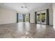 Spacious living room with tile floors, large arched windows, and doors to a covered patio, perfect for entertaining at 996 Fairview Ave, Mount Dora, FL 32757