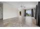 Bright, spacious living room with tray ceiling, tile floors, and stunning water views through a large arched window at 996 Fairview Ave, Mount Dora, FL 32757