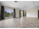 Expansive living room with arched windows, tile flooring, and a ceiling fan that adds comfort at 996 Fairview Ave, Mount Dora, FL 32757