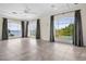 Large living room featuring beautiful waterfront views from the arched windows at 996 Fairview Ave, Mount Dora, FL 32757