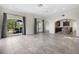 A view of the living room with a kitchen view and large windows at 996 Fairview Ave, Mount Dora, FL 32757
