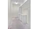 A well-lit storage room with bright white cabinets, drawers, and hanging racks at 996 Fairview Ave, Mount Dora, FL 32757