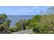 Expansive water view showcases the tranquil waterfront framed by mature trees, highlighting the scenic surroundings at 996 Fairview Ave, Mount Dora, FL 32757
