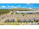 Community aerial view of modern townhomes with manicured lawns and proximity to industrial parks at 10940 Leafshore Loop, Orlando, FL 32829