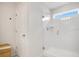 Modern bathroom featuring a glass-enclosed shower with white tiles and natural light from a window at 10940 Leafshore Loop, Orlando, FL 32829