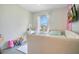 Cozy bedroom with a window offering an outside view, a charming vanity, and a comfortable bed at 10940 Leafshore Loop, Orlando, FL 32829