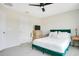 Bright bedroom featuring a large window, modern decor, and plush carpeting at 10940 Leafshore Loop, Orlando, FL 32829