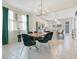 Elegant dining room with tile flooring, modern light fixture, and open access to the kitchen at 10940 Leafshore Loop, Orlando, FL 32829