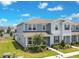 Charming two-story exterior with light blue siding, a well-manicured lawn, and lush landscaping at 10940 Leafshore Loop, Orlando, FL 32829