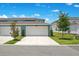 Attached garages showing paved driveway and landscaping at 10940 Leafshore Loop, Orlando, FL 32829
