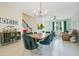 Bright living room featuring modern chandelier, open staircase, and an abundance of natural light at 10940 Leafshore Loop, Orlando, FL 32829