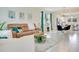 Bright living room features tile flooring, modern furnishings, and an open layout to the dining area at 10940 Leafshore Loop, Orlando, FL 32829