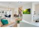 Comfortable living room with tile floors, stairs, adjacent dining area, and access to other living spaces at 10940 Leafshore Loop, Orlando, FL 32829