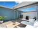 Outdoor patio area with seating, a grill, and a well-maintained paver surface for relaxation at 10940 Leafshore Loop, Orlando, FL 32829