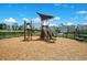 Community playground with a climbing structure, slide, and a wood chip surface for safety at 10940 Leafshore Loop, Orlando, FL 32829
