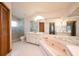 Bathroom featuring a large tub, shower, and ample counter space with storage cabinets at 1130 Woodchuck Ct, Orange City, FL 32763
