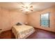 Cozy bedroom with patterned wallpaper, carpet flooring, ceiling fan and a comfortable bed at 1130 Woodchuck Ct, Orange City, FL 32763