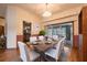 Dining room with a wooden table and chairs with sliding glass door leading to the pool at 1130 Woodchuck Ct, Orange City, FL 32763