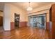Dining room with hardwood floors leading to an outdoor enclosed screen pool at 1130 Woodchuck Ct, Orange City, FL 32763