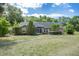 Charming single-story brick home with a well-maintained lawn and mature trees at 1130 Woodchuck Ct, Orange City, FL 32763