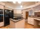 Cozy kitchen features black appliances, granite counters, a central island cooktop at 1130 Woodchuck Ct, Orange City, FL 32763