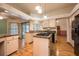 Bright kitchen featuring granite counters, black appliances, and tiled backsplash at 1130 Woodchuck Ct, Orange City, FL 32763