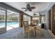 Covered lanai featuring ceiling fans, dining furniture, and view of screened pool at 1130 Woodchuck Ct, Orange City, FL 32763