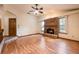 Spacious living room featuring a wood burning fireplace and hardwood floors at 1130 Woodchuck Ct, Orange City, FL 32763