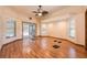 Living room with hardwood floors and a view of the screen enclosed pool at 1130 Woodchuck Ct, Orange City, FL 32763